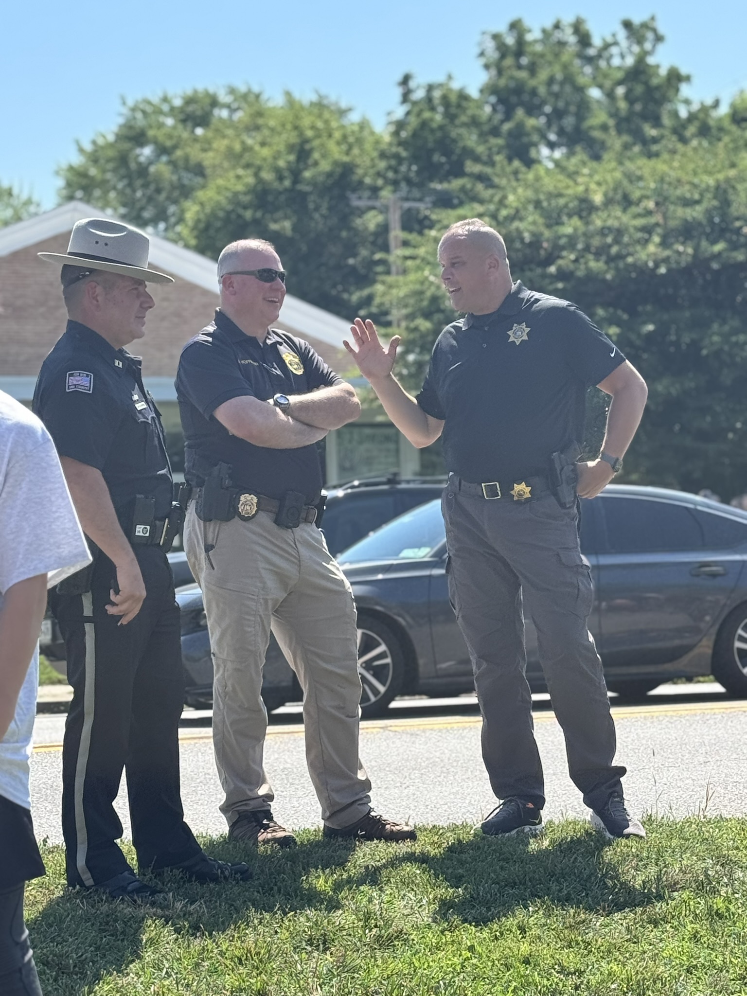 Brian Hess speaking with public safety partners outdoors